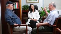 Doctor speaks with two patients